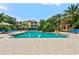 Community pool surrounded by lush greenery, ideal for relaxation and recreation in a tropical setting at 4207 S Dale Mabry Hwy # 3302, Tampa, FL 33611