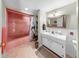 Traditional bathroom featuring pink tile, a single vanity, and a tub with shower at 500 Oleander S Way, St Petersburg, FL 33707