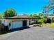 A well maintained single story home with a driveway and garage, featuring manicured landscaping, and modern design at 500 Oleander S Way, St Petersburg, FL 33707