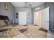 Bedroom featuring patterned bedding, bedside table, and multiple doorways at 5524 Yellowfin Ct, New Port Richey, FL 34652