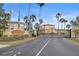 Gated entrance to the Sea Forest Townhomes with palm trees and tropical landscaping on a sunny day at 5524 Yellowfin Ct, New Port Richey, FL 34652
