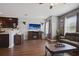 Stylish living room connecting to the kitchen, featuring a stone accent wall and modern furnishings at 5524 Yellowfin Ct, New Port Richey, FL 34652