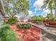 Large backyard with a combination of brick and wood features, lush landscaping and mature trees providing ample shade at 5533 97Th N Way, St Petersburg, FL 33708