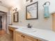 Bright bathroom with a classic vanity, framed mirror and a towel rack with a decorative mint green towel at 5533 97Th N Way, St Petersburg, FL 33708