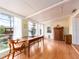 Sunlit dining area featuring wood floors, classic furnishings, and serene garden views at 5533 97Th N Way, St Petersburg, FL 33708
