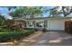 Charming single-story home with well-manicured landscaping and brick-paved driveway at 5533 97Th N Way, St Petersburg, FL 33708