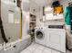 Efficient laundry area with modern washer, dryer, and organized shelving for storage at 5533 97Th N Way, St Petersburg, FL 33708