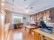 Eclectic living space featuring a guitar wall, rich wood floors, and plenty of natural light at 5533 97Th N Way, St Petersburg, FL 33708