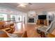Spacious living room with a fireplace, wood floors, and access to the bright sunroom at 5533 97Th N Way, St Petersburg, FL 33708