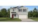 Charming two-story home with a landscaped yard and a two-car garage at 5631 Red Kite Dr, Wimauma, FL 33598