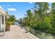 Scenic backyard canal view with lush tropical landscaping at 636 Tarawitt Dr, Longboat Key, FL 34228