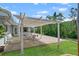 Outdoor space featuring a covered patio with space for a dining area and landscaping at 636 Tarawitt Dr, Longboat Key, FL 34228