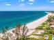Stunning oceanfront property with lush green vegetation at 636 Tarawitt Dr, Longboat Key, FL 34228