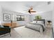 Bright bedroom featuring a ceiling fan, neutral-colored walls, decor, and large windows allowing natural light at 636 Tarawitt Dr, Longboat Key, FL 34228