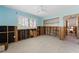 Bedroom featuring exposed framing, new flooring, updated windows, and light blue walls at 636 Tarawitt Dr, Longboat Key, FL 34228