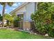 Exterior view of the home with the AC unit, landscaping and garden at 636 Tarawitt Dr, Longboat Key, FL 34228
