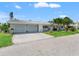 Inviting single-story home with an attached two-car garage and well-kept front yard at 636 Tarawitt Dr, Longboat Key, FL 34228