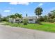 Single-story home with mature landscaping and well-maintained lawn and a three-car garage at 636 Tarawitt Dr, Longboat Key, FL 34228
