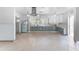 Renovated kitchen with updated two-tone cabinets, tile flooring, stainless steel appliances, and ample counter space at 636 Tarawitt Dr, Longboat Key, FL 34228