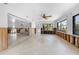 Bright living room featuring tile flooring, large windows and ceiling fan awaiting renovation at 636 Tarawitt Dr, Longboat Key, FL 34228