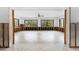 Large living room with tiled floor and large picture windows at 636 Tarawitt Dr, Longboat Key, FL 34228