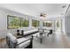 Large living room with tiled floor and large picture windows and modern seating at 636 Tarawitt Dr, Longboat Key, FL 34228