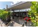 Inviting outdoor patio area with comfortable seating and lush landscaping at 636 Tarawitt Dr, Longboat Key, FL 34228