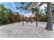 Fun community playground featuring swings and a play structure surrounded by trees at 636 Tarawitt Dr, Longboat Key, FL 34228