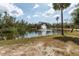 Scenic pond view with a fountain surrounded by lush greenery and blue skies at 636 Tarawitt Dr, Longboat Key, FL 34228