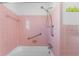 Vintage-style pink tiled shower featuring safety bars and a handheld shower head at 636 Tarawitt Dr, Longboat Key, FL 34228