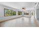 Light-filled sunroom with tile flooring, multiple windows offering serene views of the surrounding greenery at 636 Tarawitt Dr, Longboat Key, FL 34228