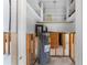 View of a utility room showcasing a hot water heater and exposed framework, in need of repair at 636 Tarawitt Dr, Longboat Key, FL 34228