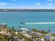 Beautiful waterfront view featuring a boat speeding across the blue water on a sunny day at 636 Tarawitt Dr, Longboat Key, FL 34228