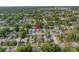 Aerial view of the property marked by a red arrow, nestled within a mature, tree-filled neighborhood at 712 43Rd N Ave, St Petersburg, FL 33703