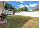 Spacious backyard featuring a well-maintained lawn, a white privacy fence, and outdoor seating at 712 43Rd N Ave, St Petersburg, FL 33703
