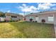 Backyard with lush green grass, an orange storage container, and an additional building at 712 43Rd N Ave, St Petersburg, FL 33703