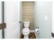 Updated half-bathroom with wood accent wall, modern toilet, and wood-look tile flooring at 712 43Rd N Ave, St Petersburg, FL 33703