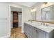 Bathroom with double sink vanity, white subway tile backsplash, and large, organized closet at 712 43Rd N Ave, St Petersburg, FL 33703