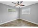 Cozy bedroom with wood-look floors, neutral paint, and two windows at 712 43Rd N Ave, St Petersburg, FL 33703