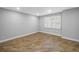 Bedroom with wood-look floors, neutral paint, and a bright window at 712 43Rd N Ave, St Petersburg, FL 33703