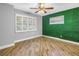 Unique bedroom featuring wood-look floors, neutral paint and an accent wall at 712 43Rd N Ave, St Petersburg, FL 33703