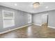 Spacious bedroom with wood-look tile flooring, recessed lights, and a decorative ceiling light fixture at 712 43Rd N Ave, St Petersburg, FL 33703