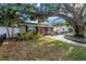 Inviting front yard showcasing a brick walkway leading to a charming home with a well-maintained lawn and landscaping at 712 43Rd N Ave, St Petersburg, FL 33703
