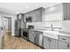 Modern kitchen with stainless steel appliances, farmhouse sink, and granite countertops at 712 43Rd N Ave, St Petersburg, FL 33703