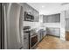 Modern kitchen with stainless steel appliances, granite counters, and updated cabinetry at 712 43Rd N Ave, St Petersburg, FL 33703