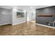 Spacious living room featuring wood-look floors, neutral paint, and accent wall at 712 43Rd N Ave, St Petersburg, FL 33703