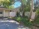 View of the side of the property, showcasing a wooden fence and mature trees in the backyard at 8609 N 11Th St, Tampa, FL 33604