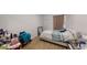 Bedroom with wood-look floors, neutral colored wall, a window with curtains and a bed with beddings at 8609 N 11Th St, Tampa, FL 33604