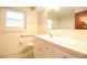 Neutral bathroom with modern sink, window, and toilet at 1001 Brookside Dr, Clearwater, FL 33764