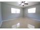 Simple bedroom featuring neutral paint and natural light from two windows at 1001 Brookside Dr, Clearwater, FL 33764
